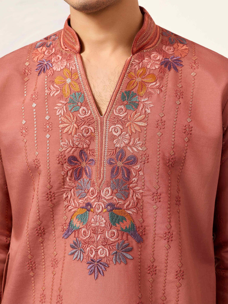 Embroidered men's kurta with floral and bird designs in vibrant colors
