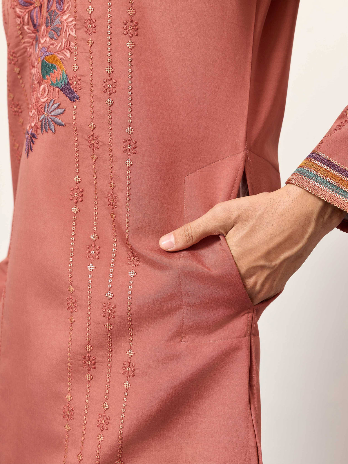 Dusty pink embroidered kurta with floral and bird motifs, detailed sleeve trim, and side pocket