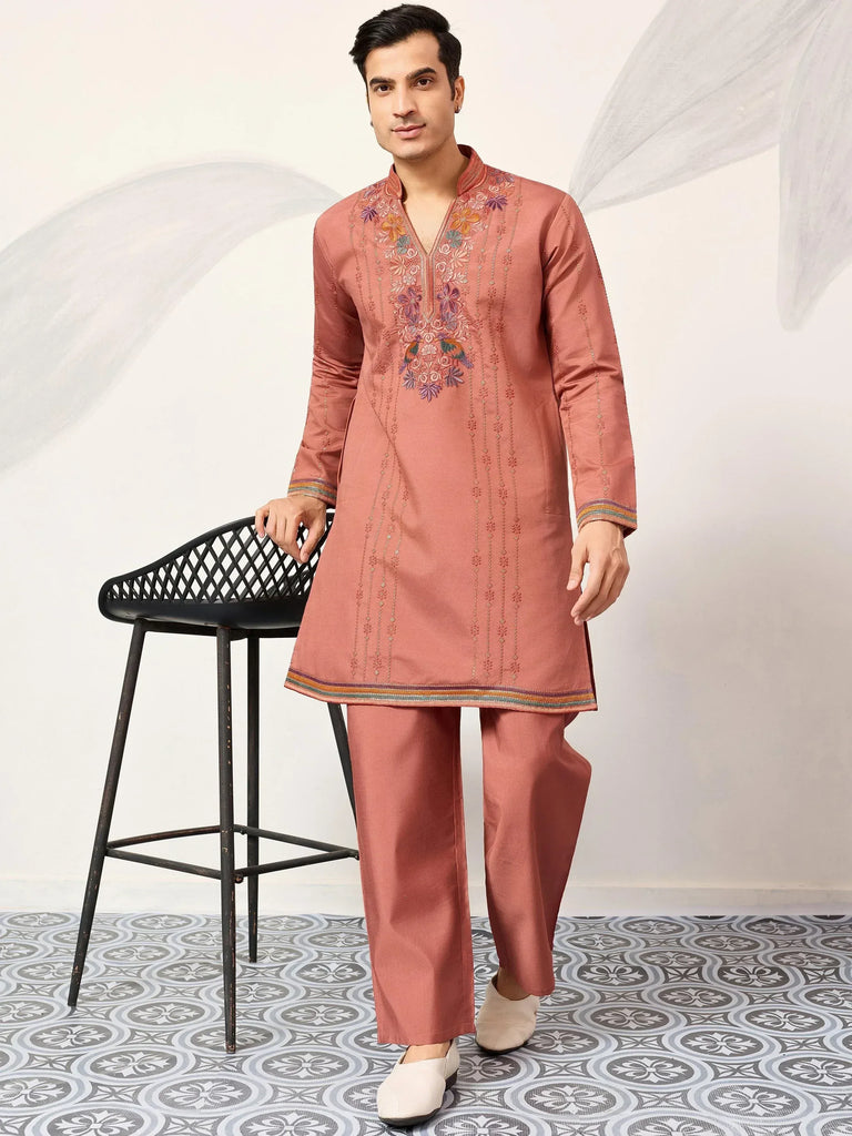 Men's embroidered kurta set in peach with floral detailing, perfect for ethnic occasions