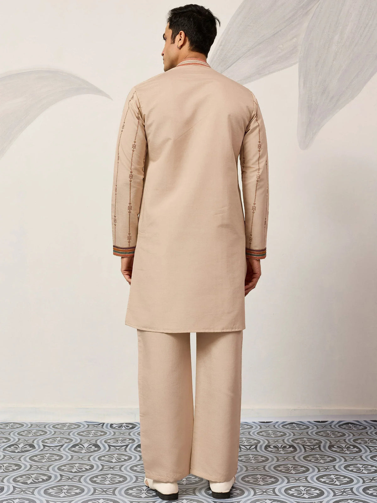 Beige men's kurta pajama set with embroidered sleeves and neckline, traditional Indian ethnic wear