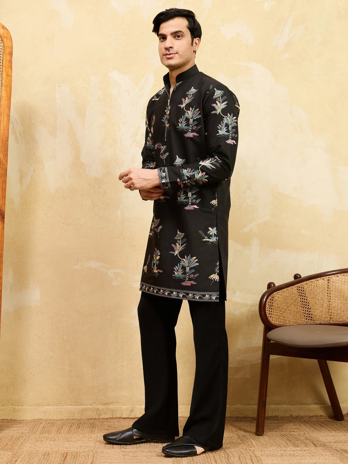 Man wearing a black floral print designer kurta and trousers