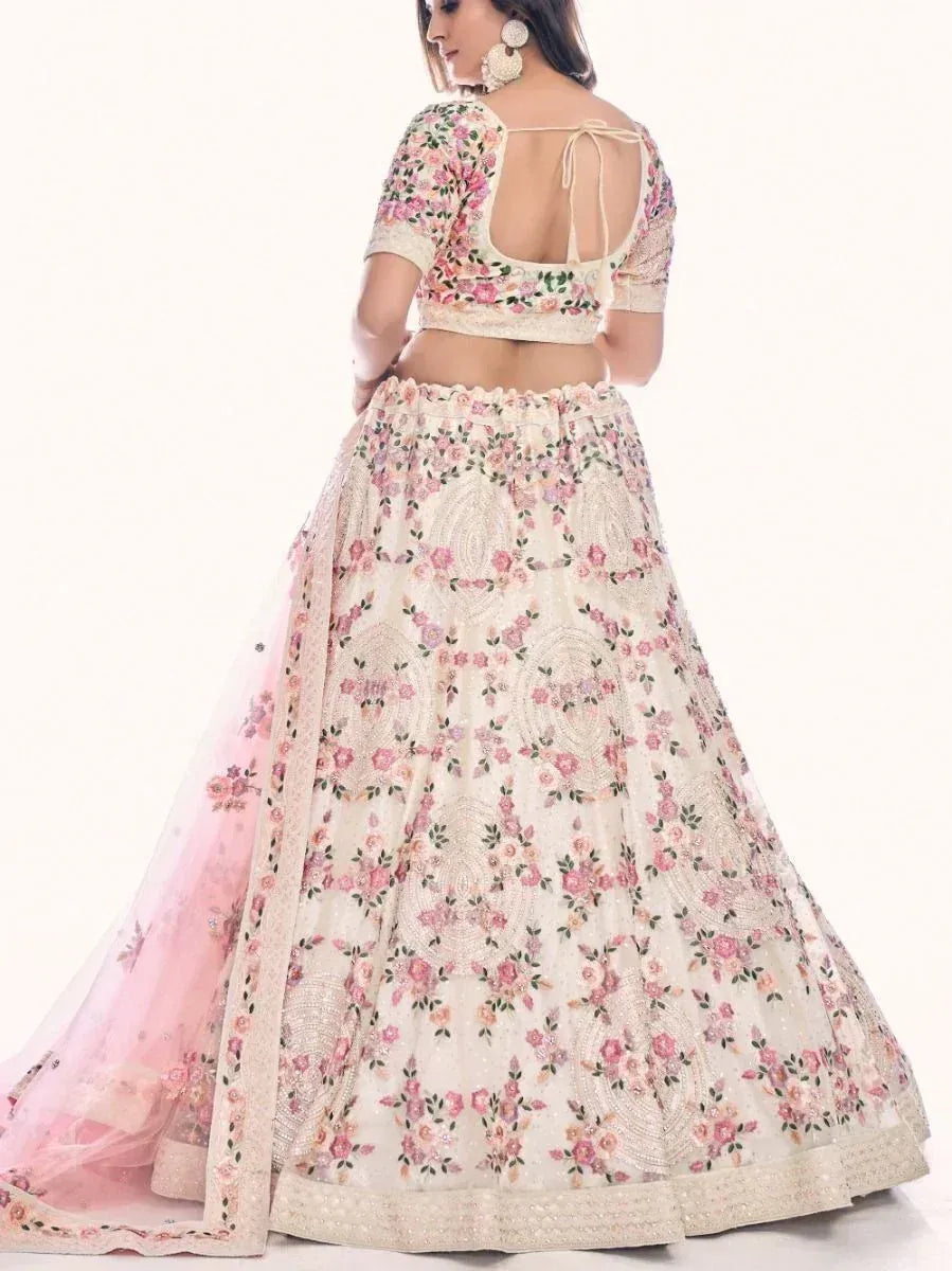 Floral embroidered lehenga choli with open back blouse and pink dupatta, perfect for Indian weddings and festivals.