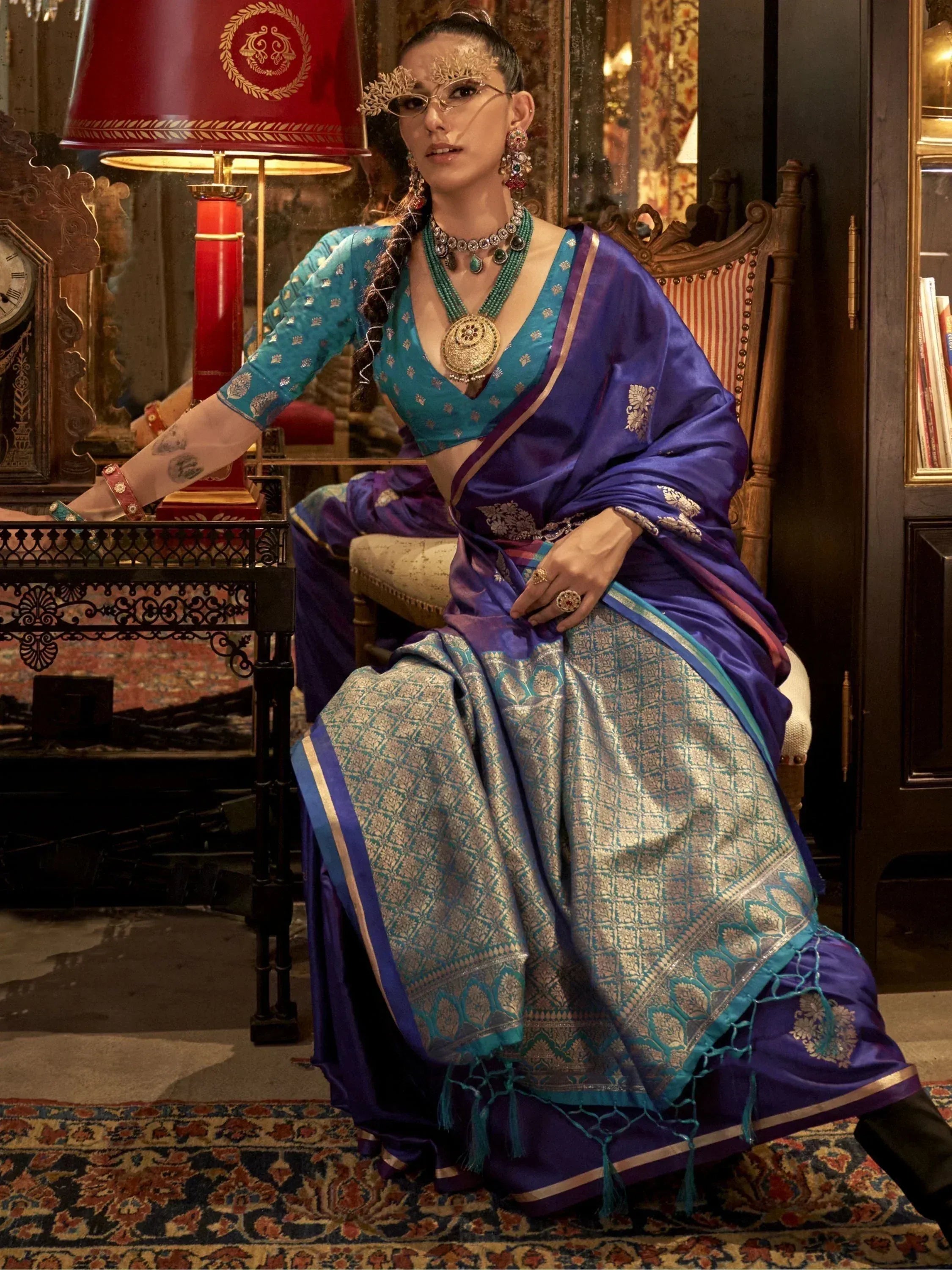 Elegant woman in royal blue and teal designer saree with gold embroidery, traditional Indian ethnic wear