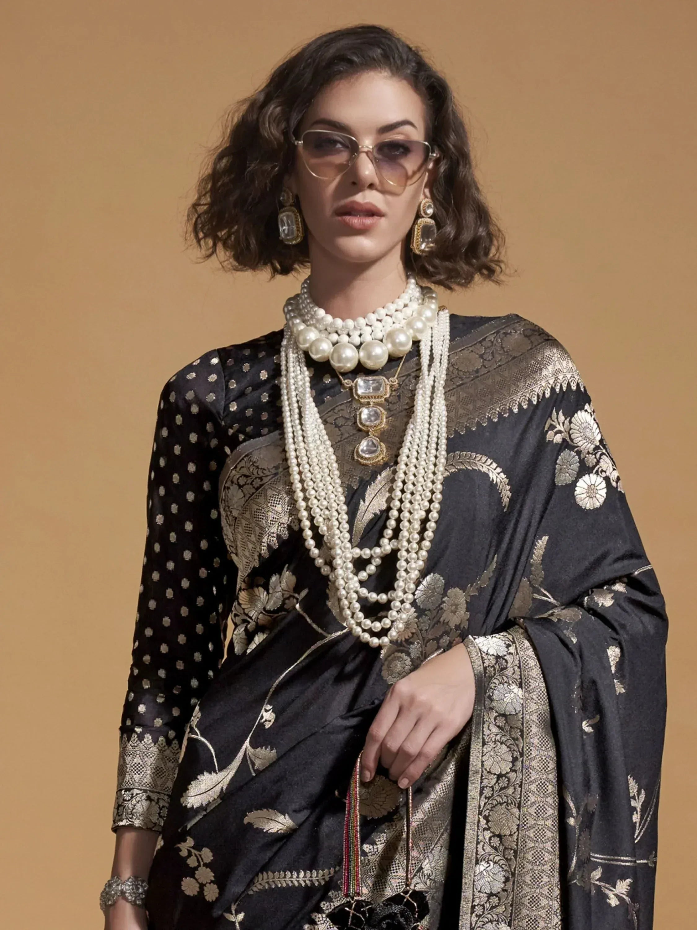 Black and gold embroidered saree with pearl jewelry, stylish ethnic wear for women