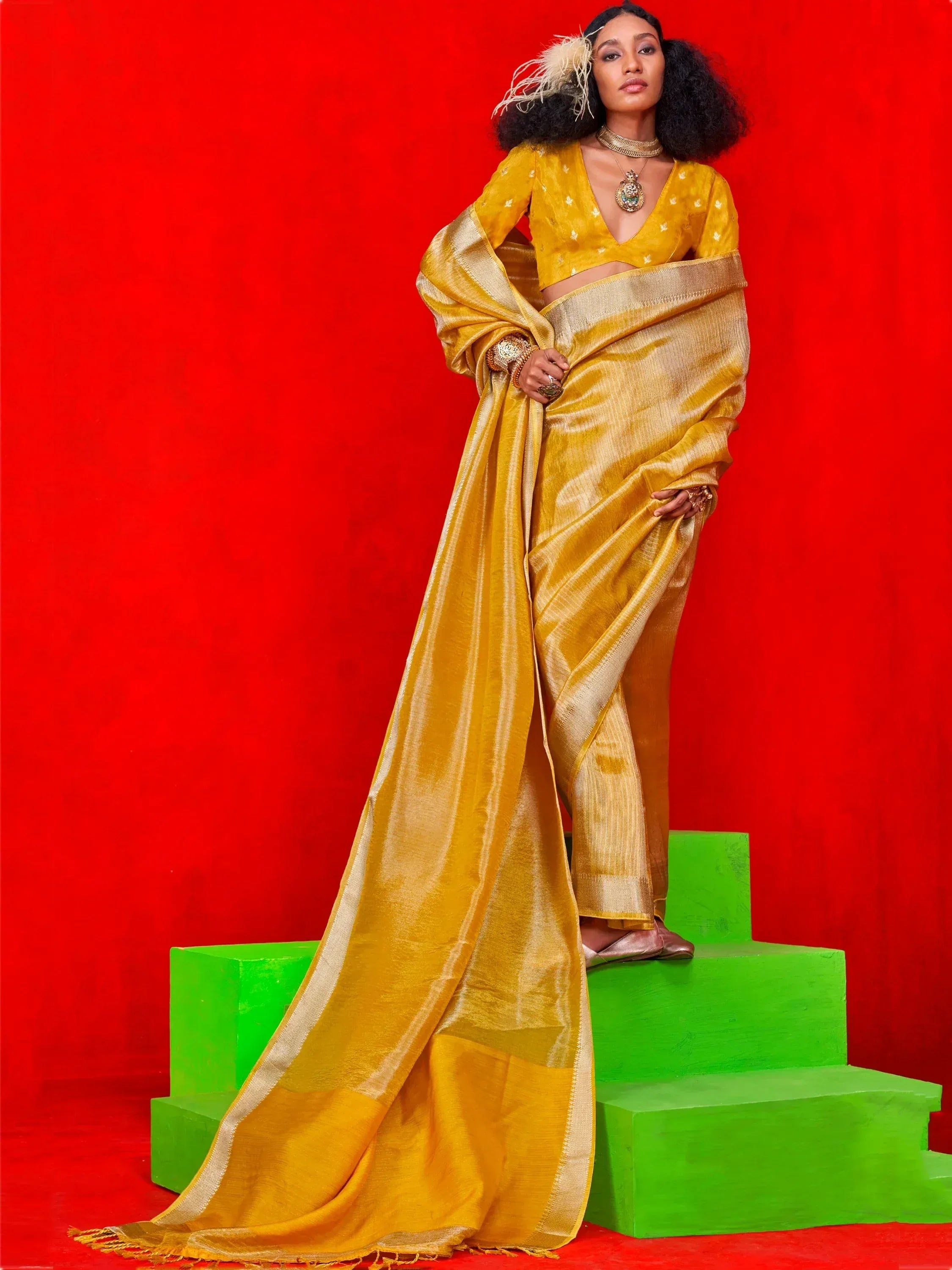 Yellow silk saree with gold border, paired with matching blouse, styled for ethnic wear occasions