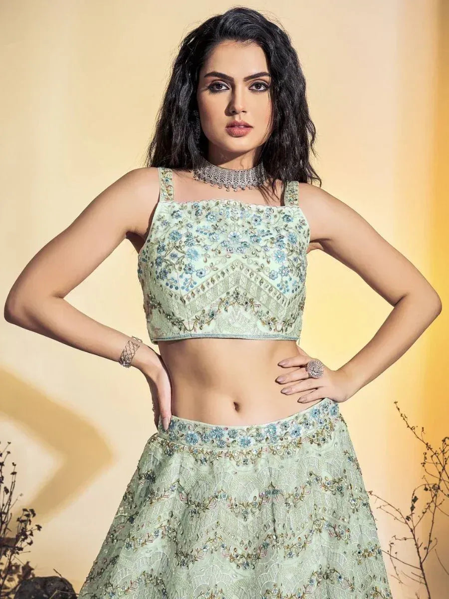 Mint green embroidered lehenga choli with floral detailing, perfect for Indian ethnic wear occasions.