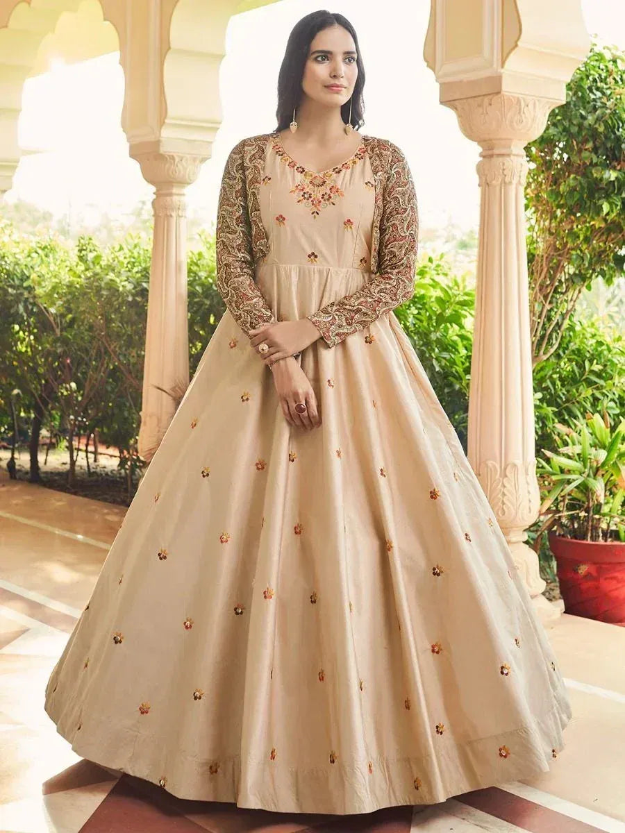 Beige floral embroidered ethnic gown with long sleeves, perfect for Indian weddings and festive occasions.