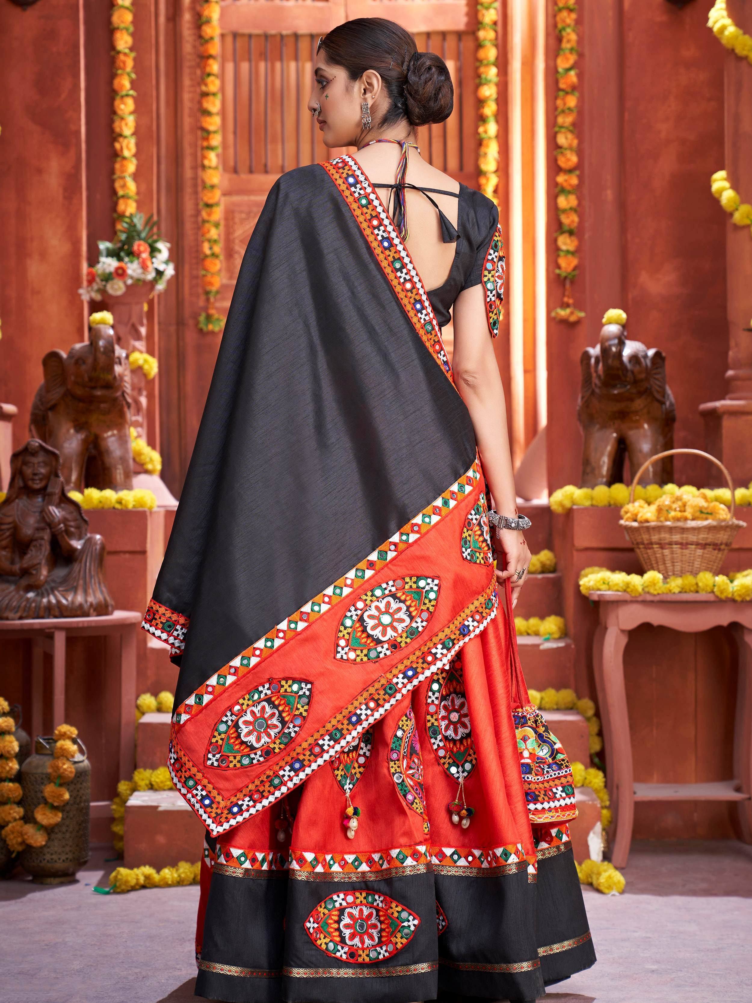 Black and orange embroidered lehenga choli with mirror work, traditional Indian ethnic wear for women