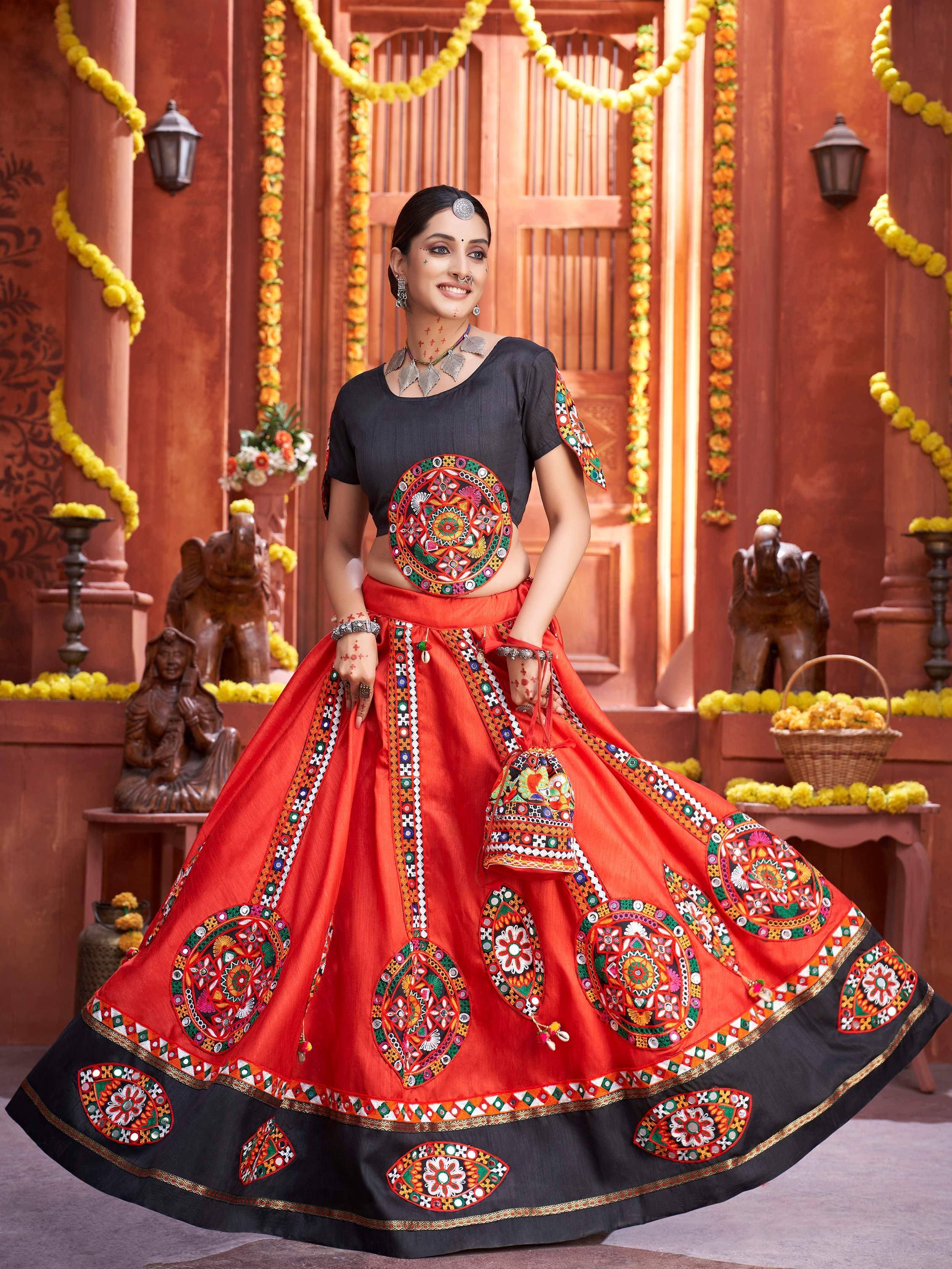Vibrant red and black embroidered lehenga choli with mirror work, perfect for Indian ethnic wear and festive occasions.