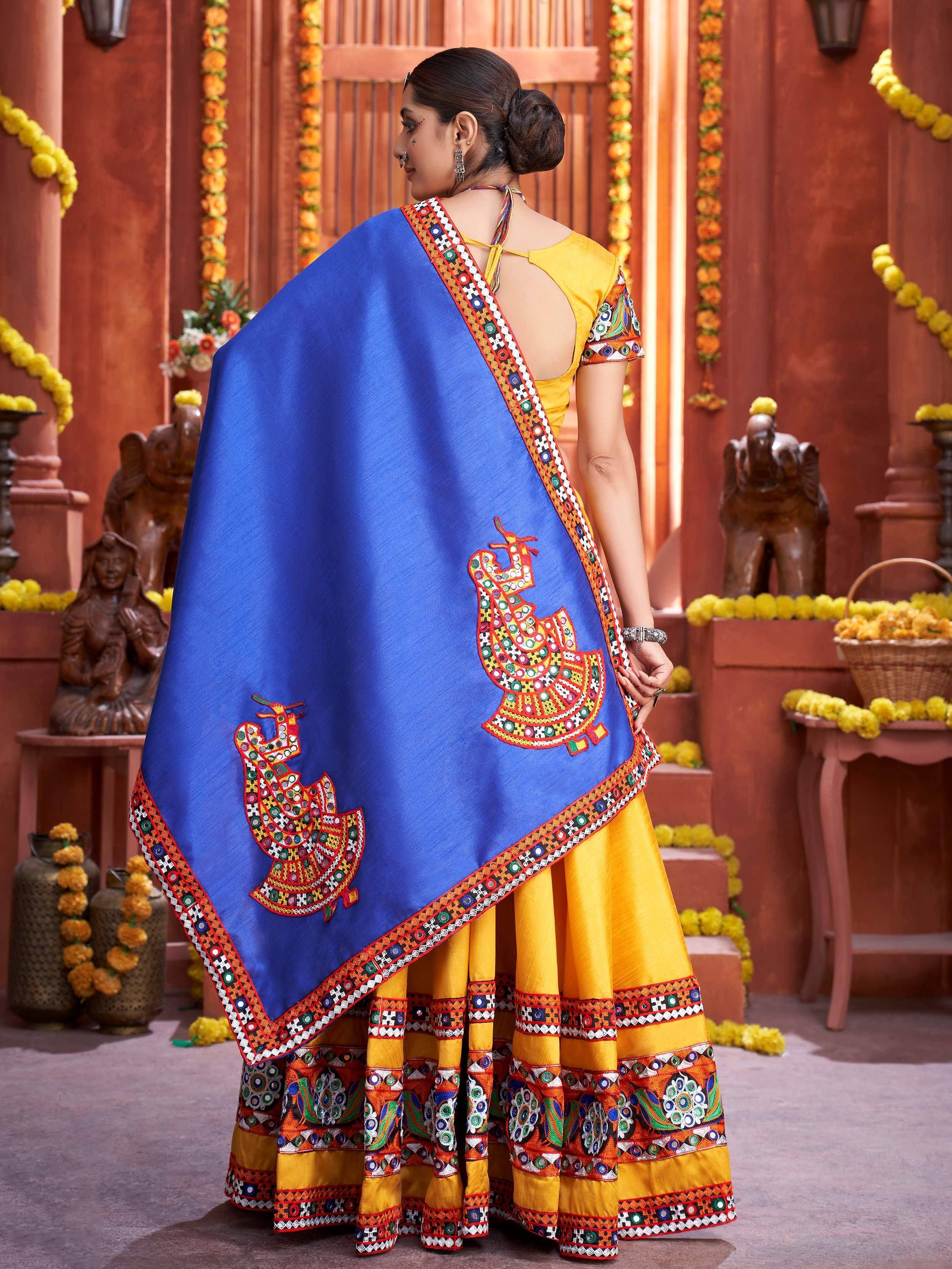 Blue and yellow ethnic lehenga choli with mirror work peacock embroidery, perfect for Indian festivals and weddings.