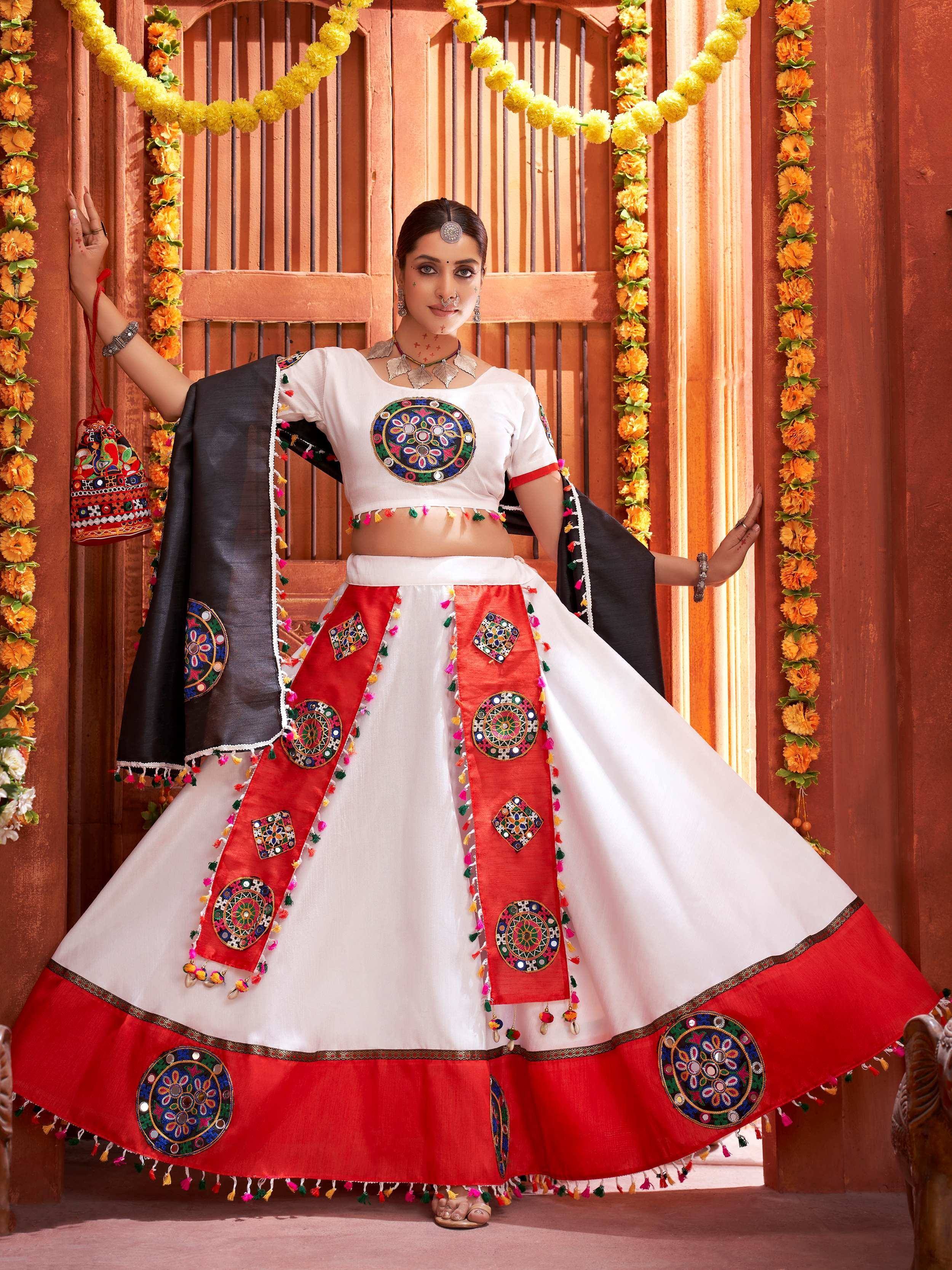 White and red ethnic chaniya choli with mirror work, perfect for Indian festivals and celebrations.
