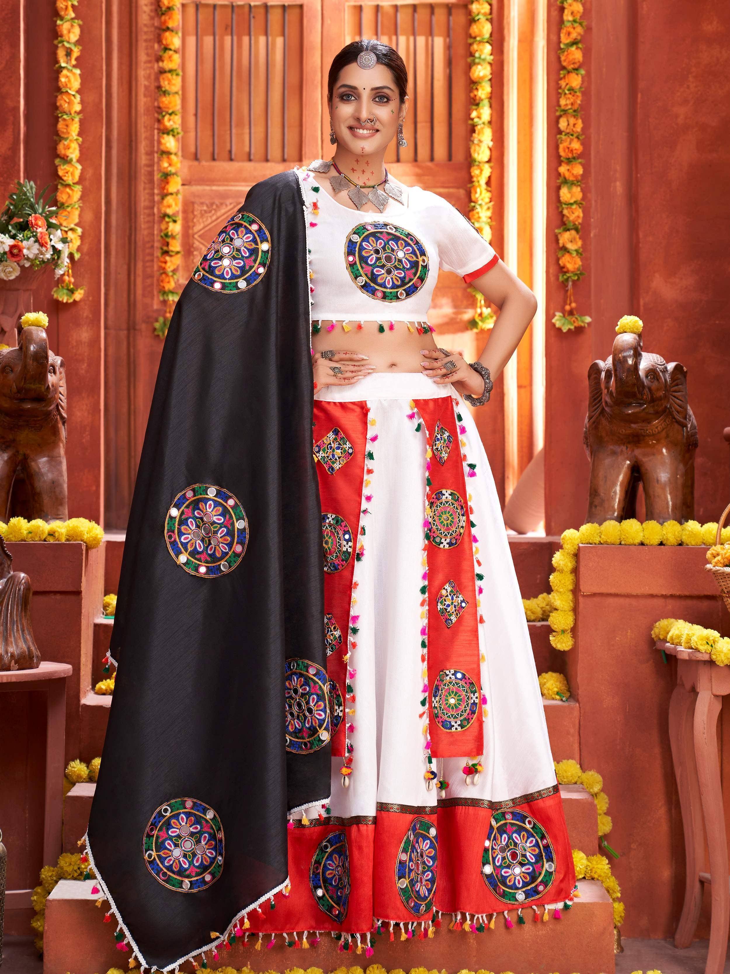 White and red embroidered ethnic lehenga choli with black dupatta, mirror work and tassels, festive Indian wear