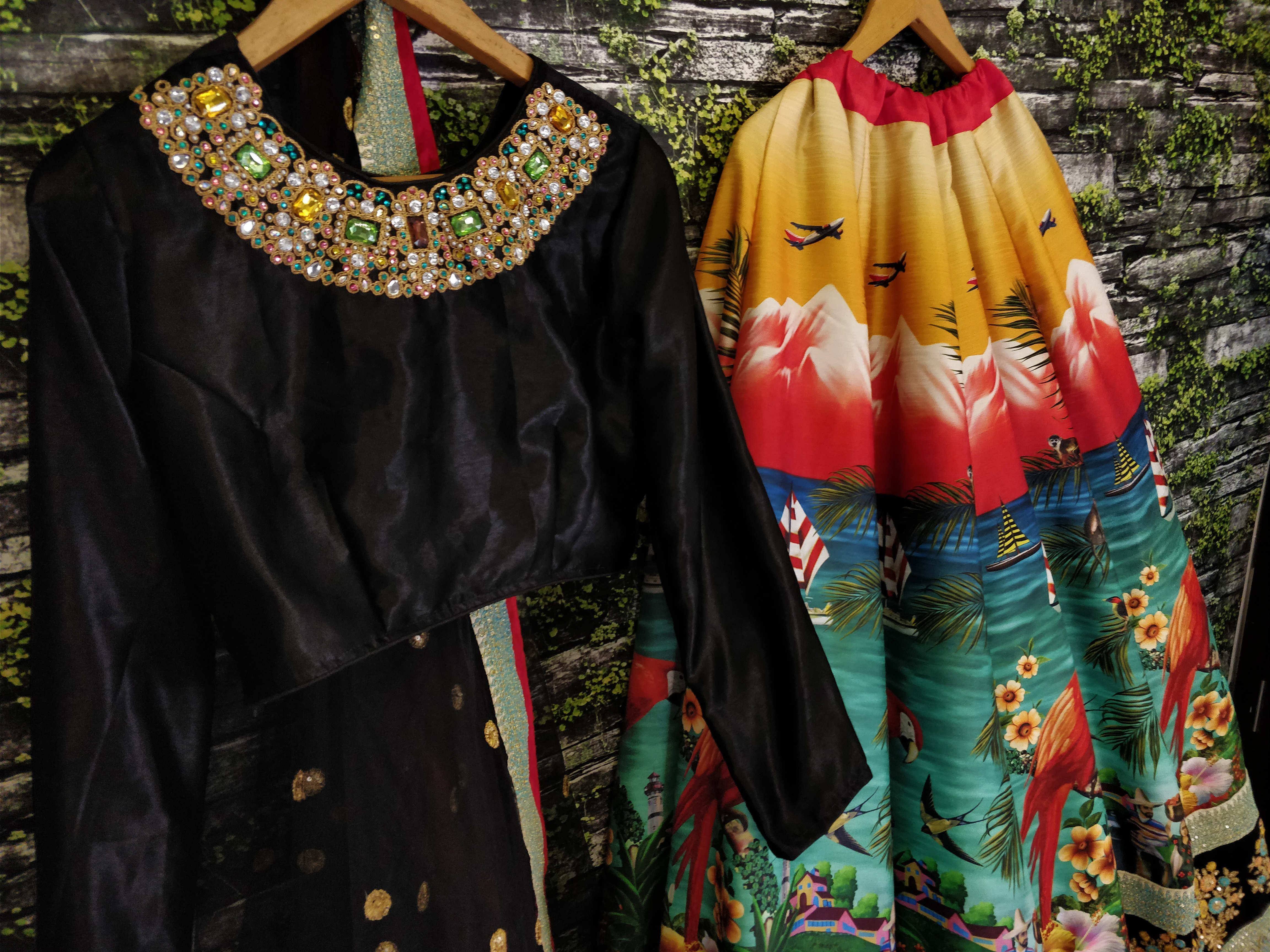 Black velvet top with jeweled neckline and colorful printed skirt, ethnic wear set
