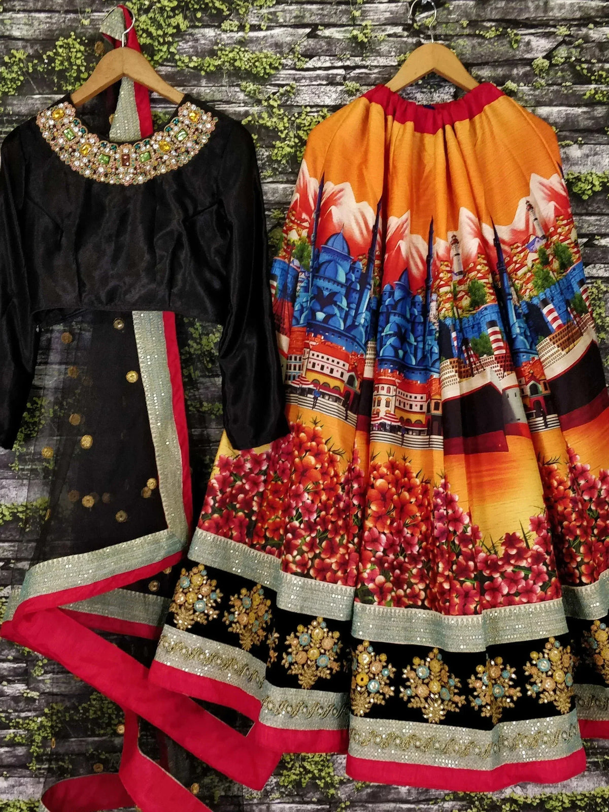 Black velvet top with jeweled neckline and printed orange skirt, ethnic wear set