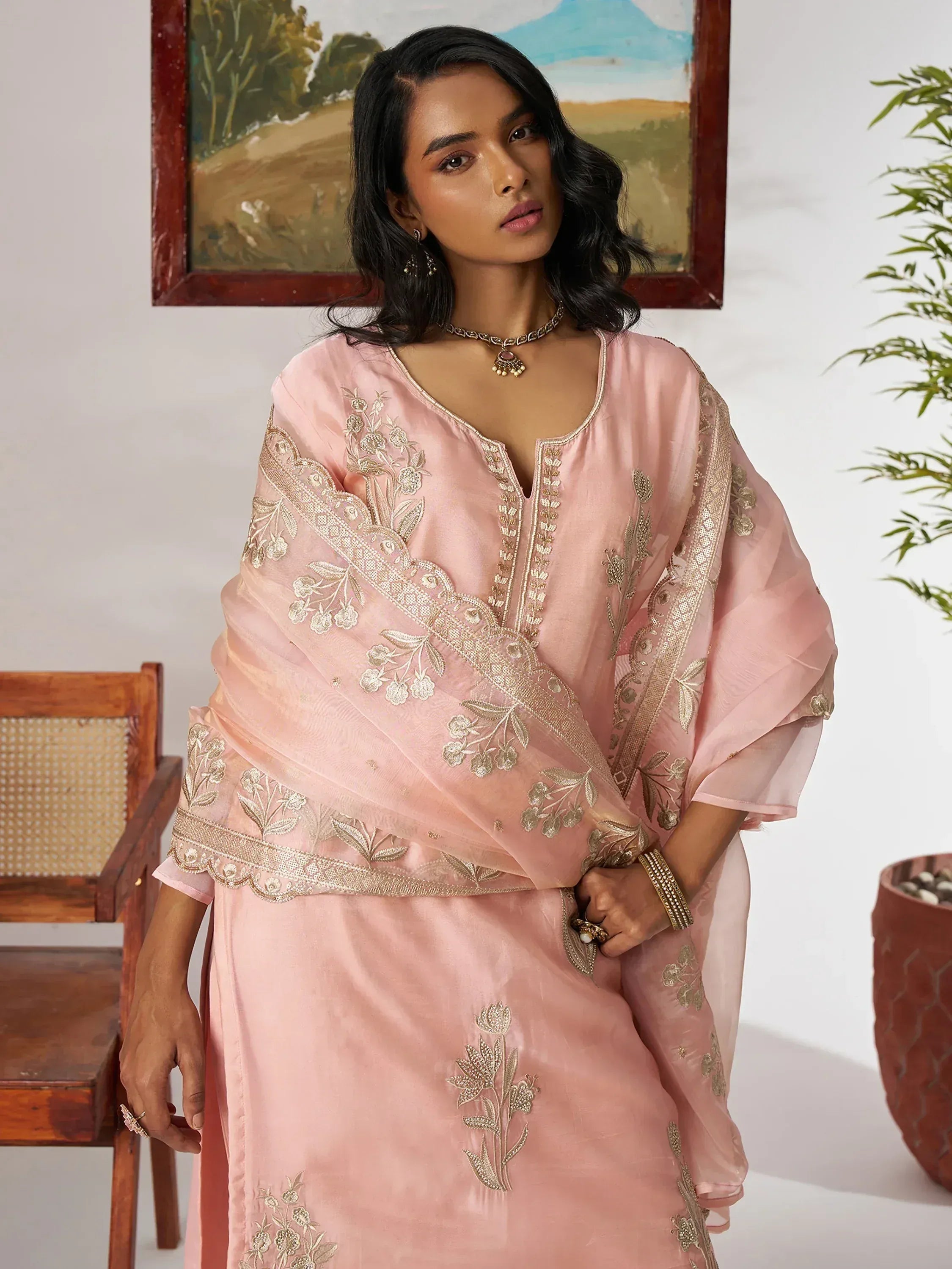 Pink embroidered salwar kameez with gold floral detailing, perfect for Indian ethnic wear occasions.