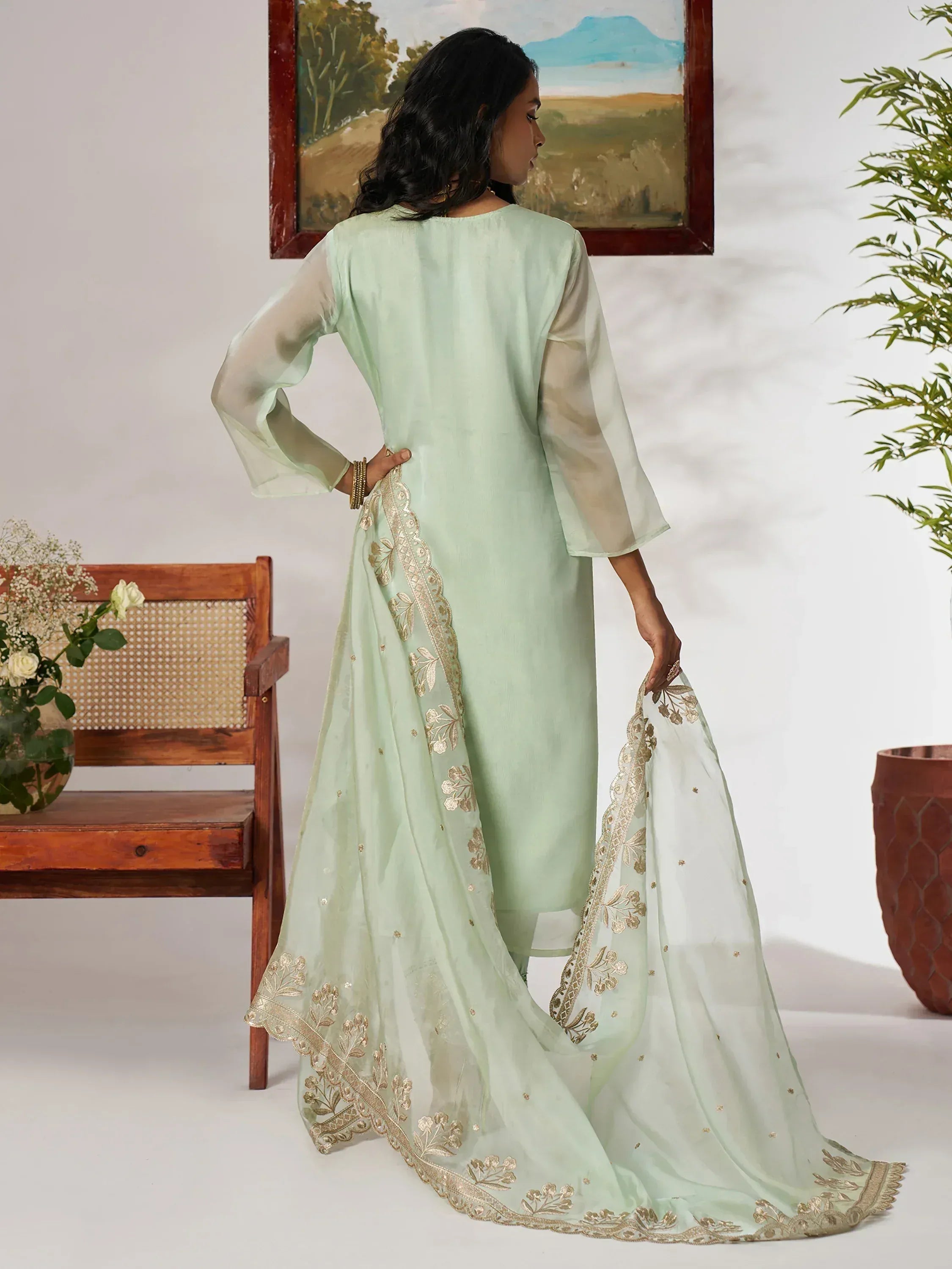 Mint green ethnic salwar kameez with gold embroidery and sheer dupatta, perfect for Indian wear occasions.