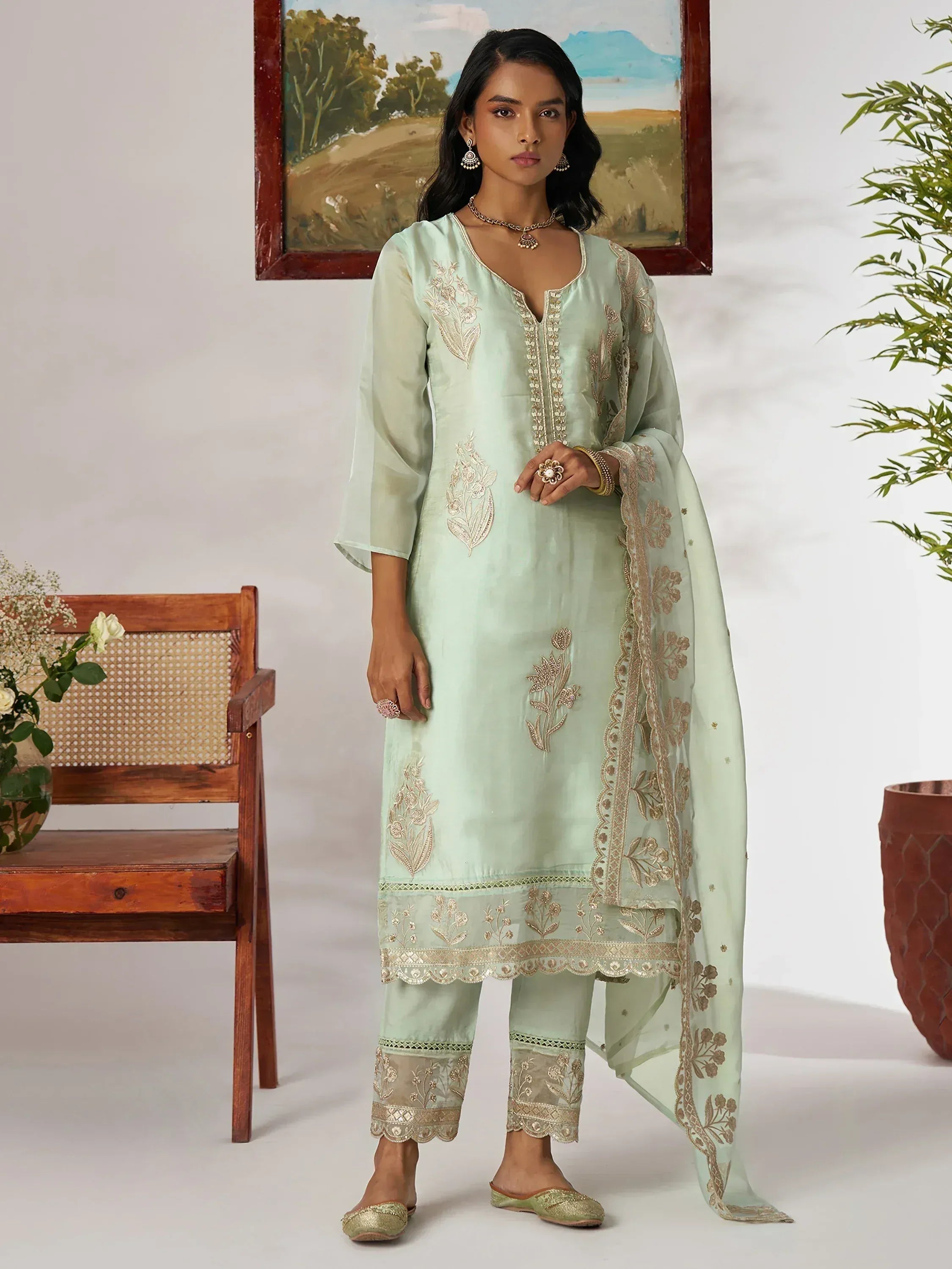 Mint green embroidered salwar kameez with gold detailing, perfect for ethnic wear and festive occasions.