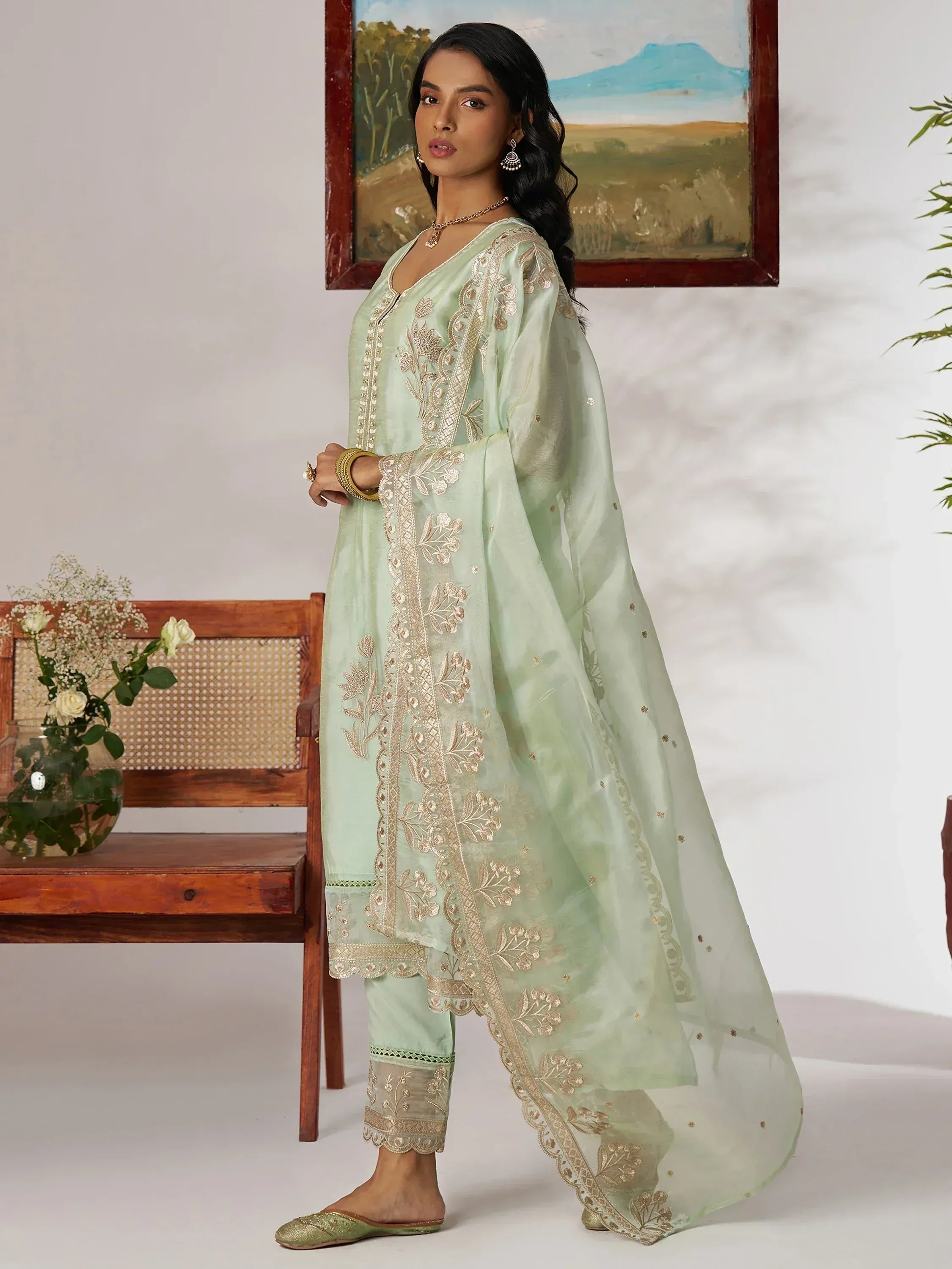 Mint green embroidered salwar kameez with gold detailing, perfect for ethnic wear occasions