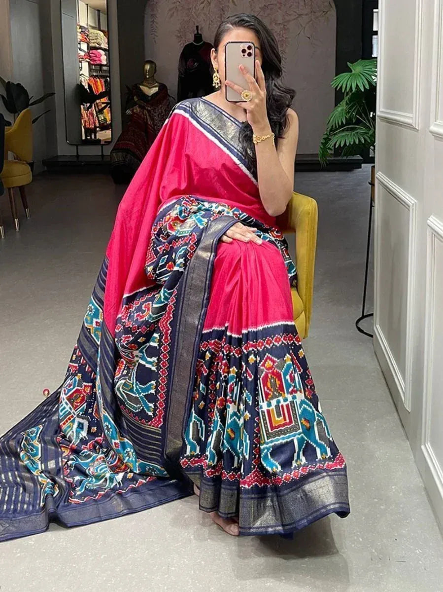 Vibrant pink and navy blue printed saree with elephant motifs, perfect for ethnic occasions