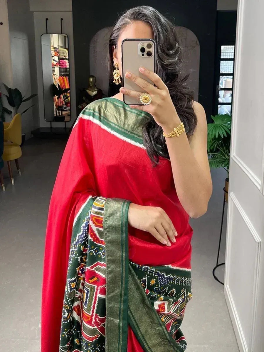 Red and green printed saree with ethnic design, perfect for traditional occasions