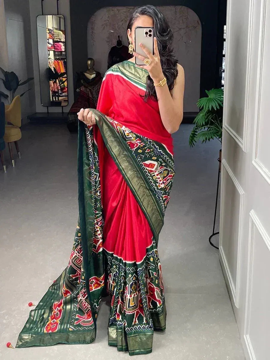 Red and green printed saree with intricate border design, perfect for ethnic occasions