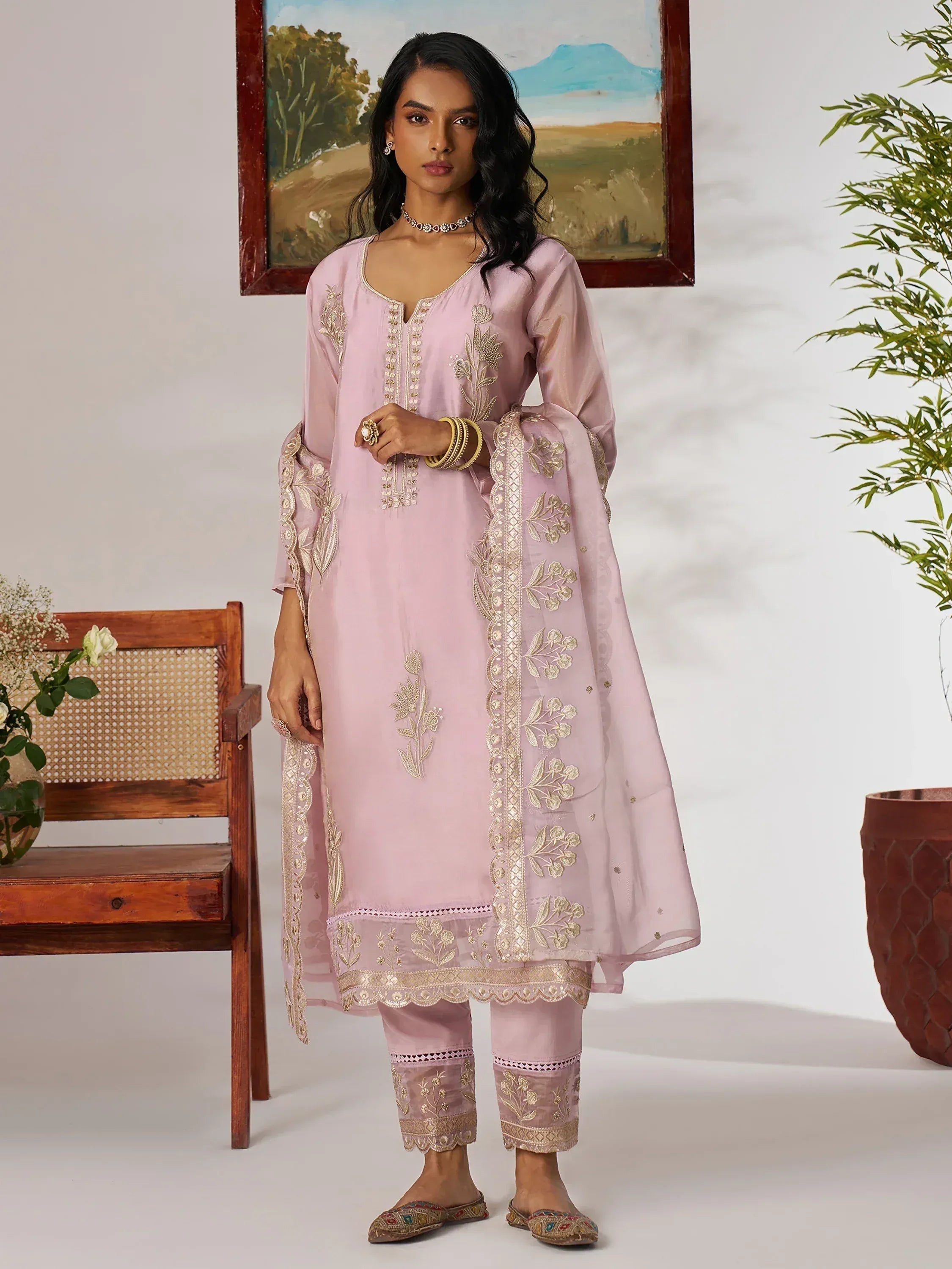 Pink embroidered salwar kameez with gold floral work, perfect for Indian ethnic wear occasions.