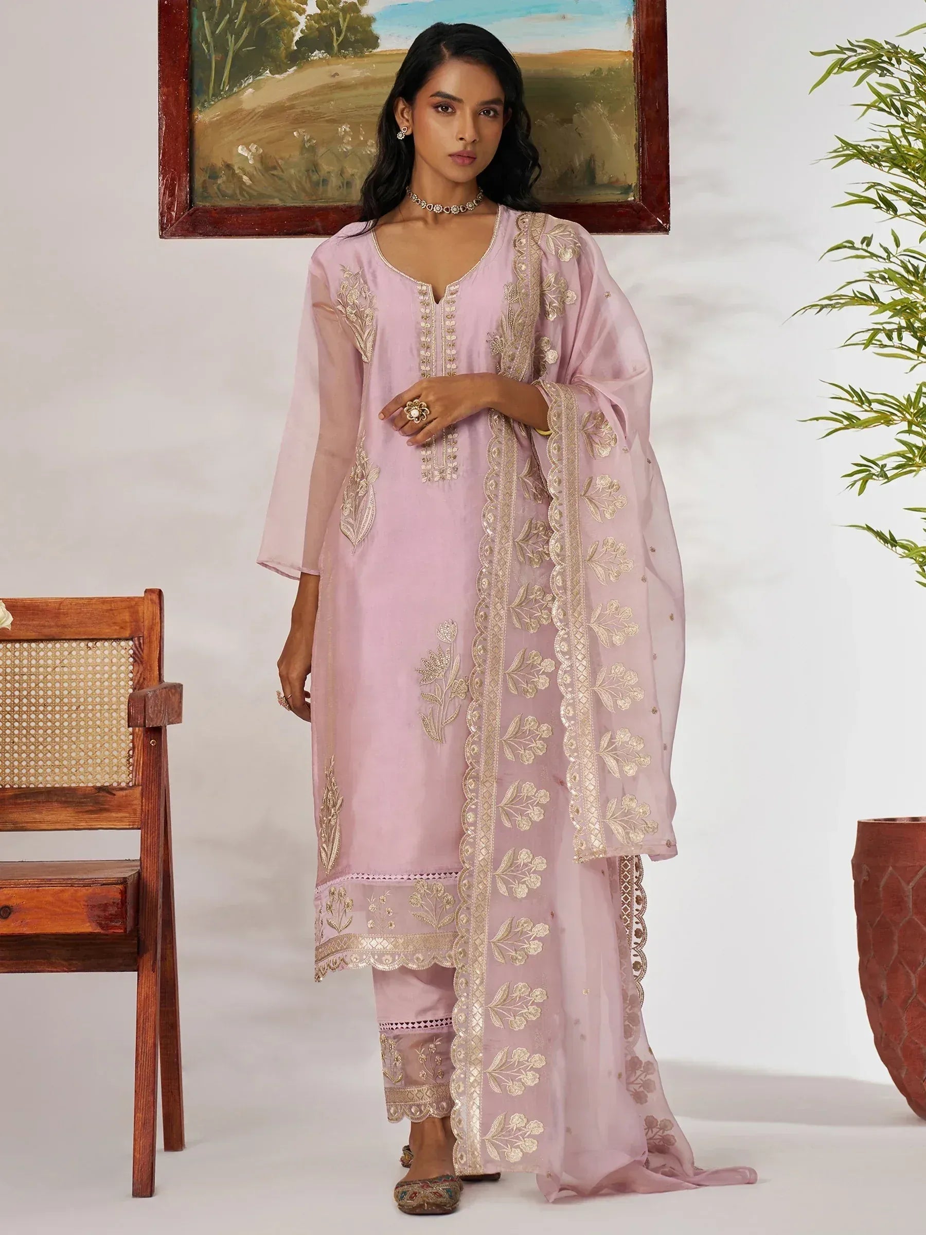 Pink embroidered salwar kameez with gold floral detailing, perfect for ethnic occasions