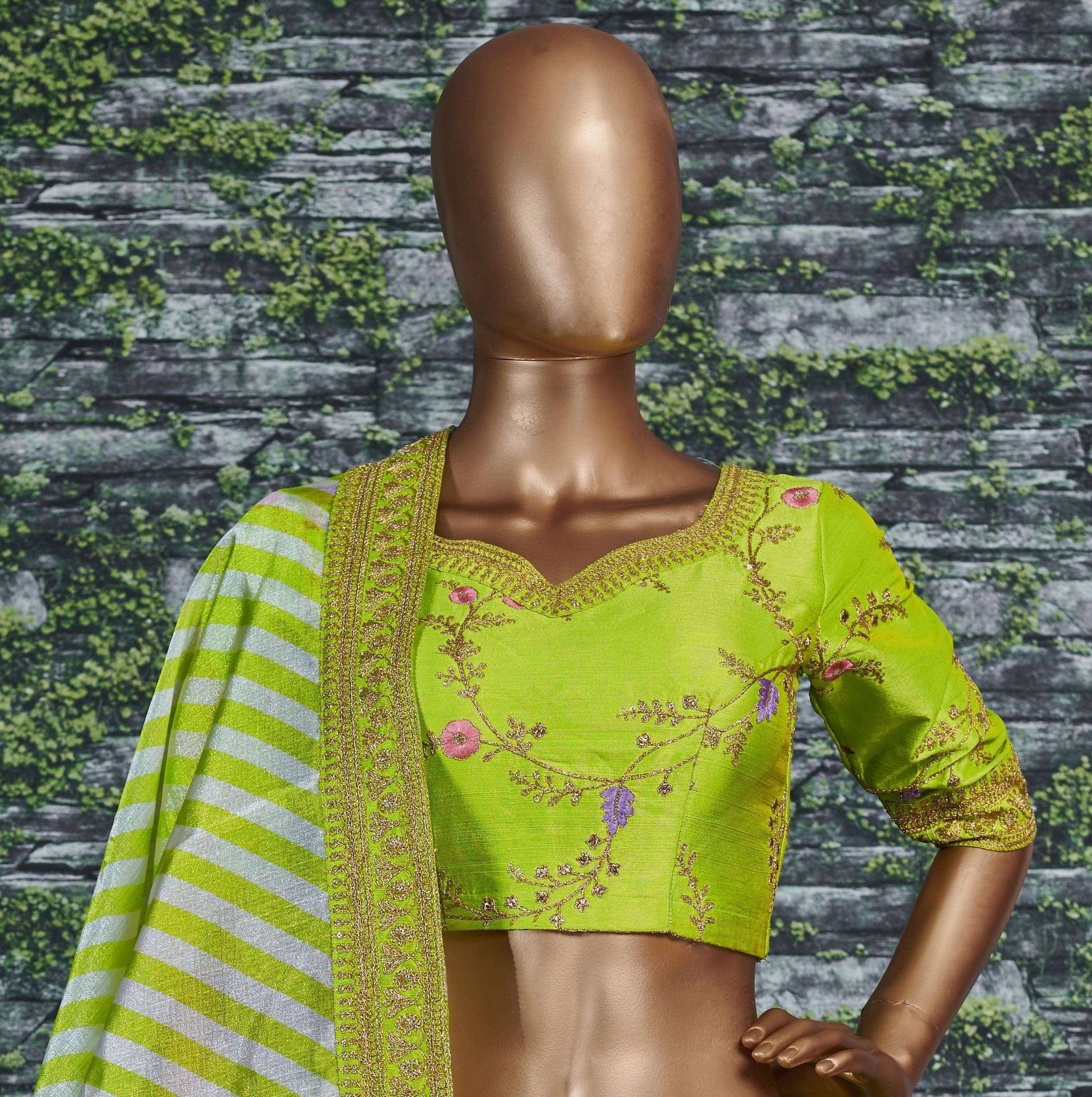 Lime green embroidered blouse with floral gold detailing and striped dupatta, displayed on mannequin