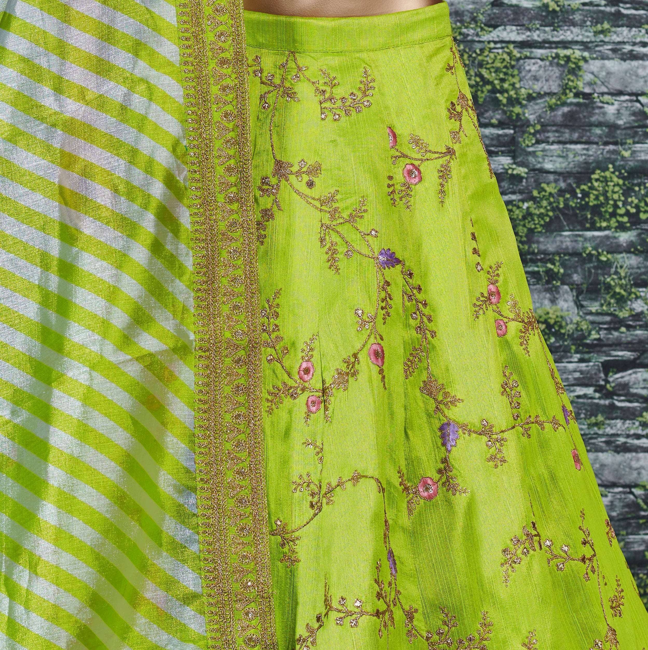 Lime green ethnic gown with gold floral embroidery and striped dupatta, perfect for Indian occasions.