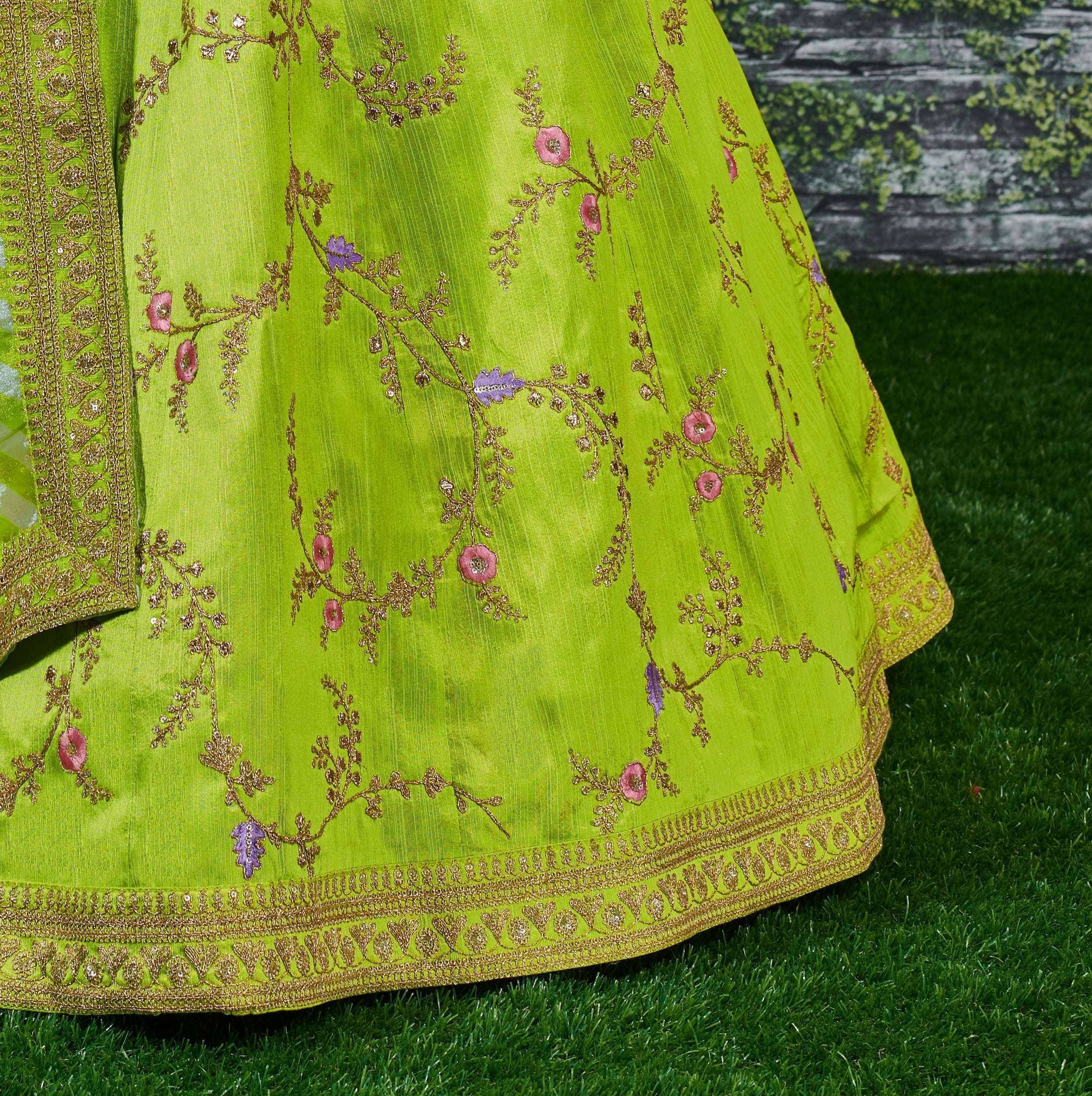 Vibrant green lehenga with gold floral embroidery and pink-purple accents, perfect for Indian ethnic wear.