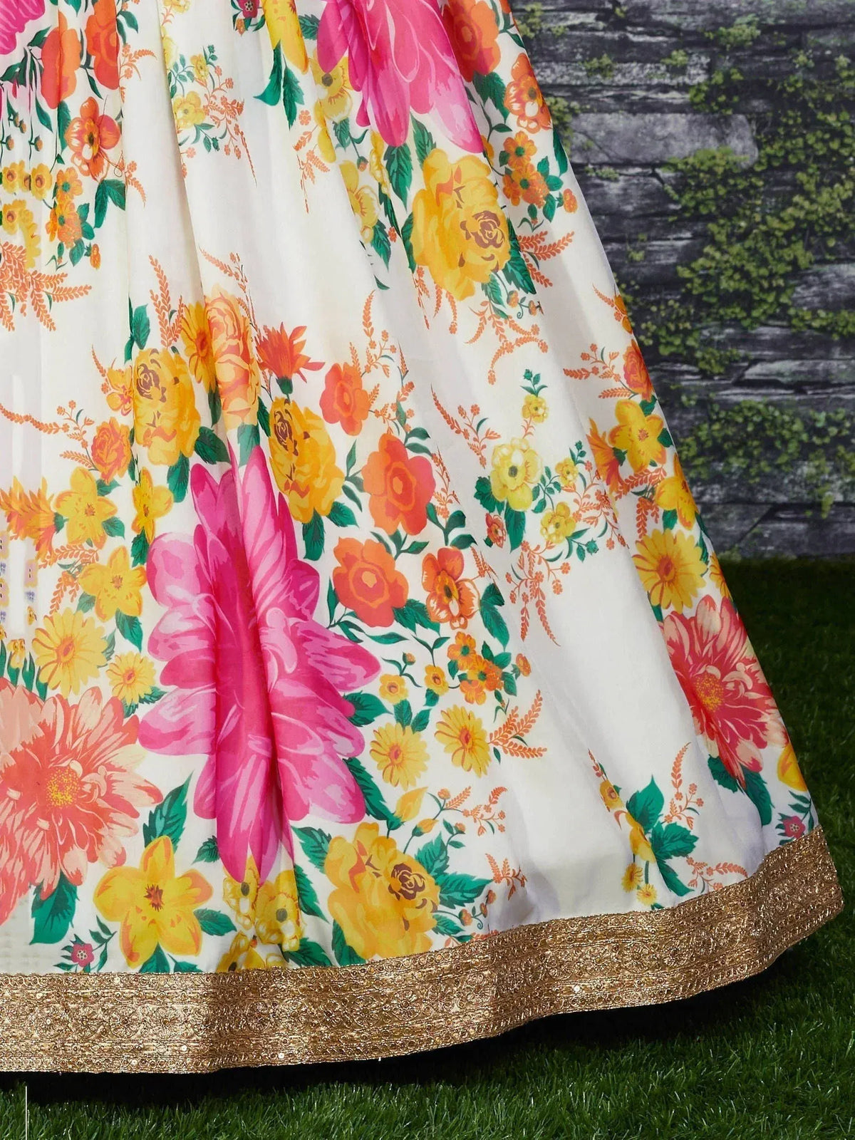 Floral print lehenga skirt with pink, yellow, orange blooms and gold border, perfect for ethnic wear