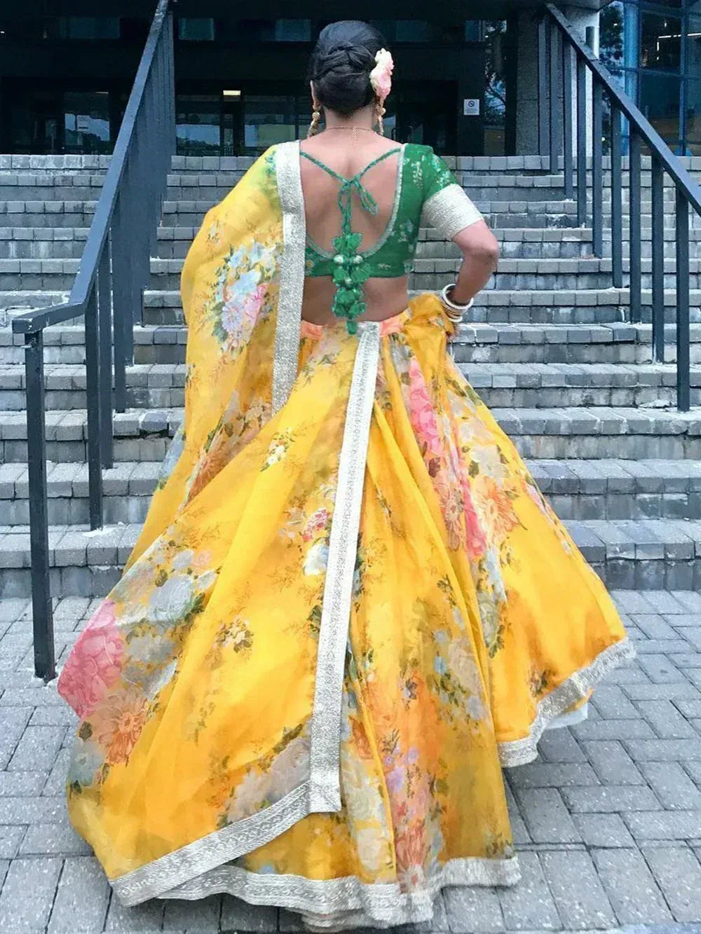 Yellow floral lehenga choli with green backless blouse, perfect for Indian ethnic wear occasions