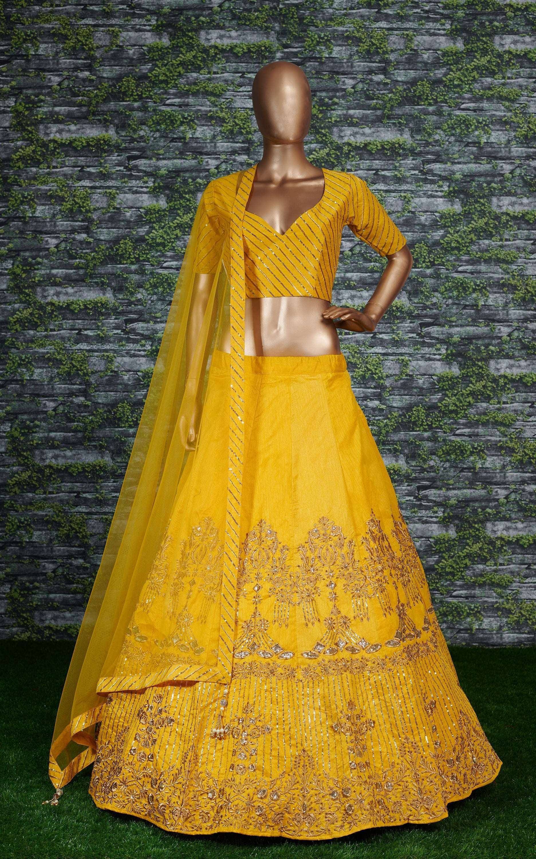 Yellow designer lehenga choli with gold embroidery and sheer dupatta, perfect for Indian ethnic occasions
