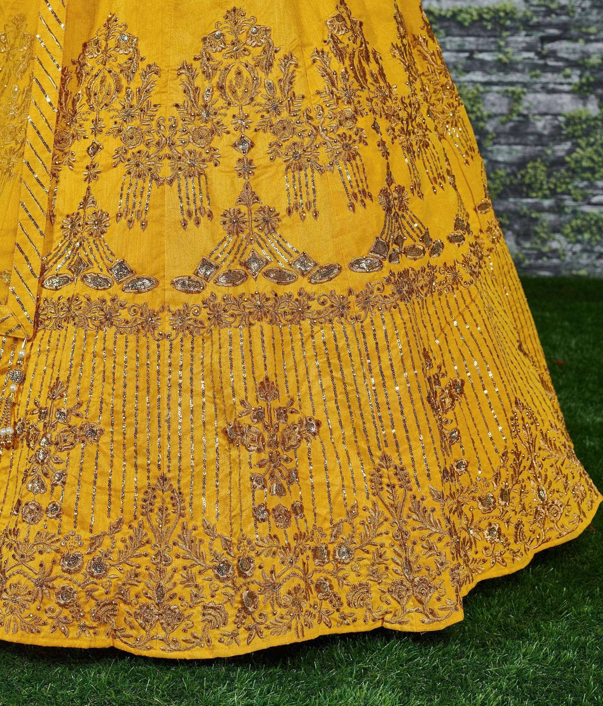 Yellow designer lehenga with intricate gold embroidery and sequin detailing, perfect for Indian ethnic wear.