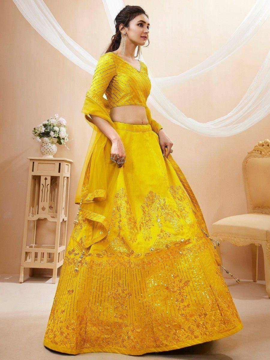 Yellow designer lehenga choli with intricate embroidery and sequin work, perfect for Indian ethnic occasions