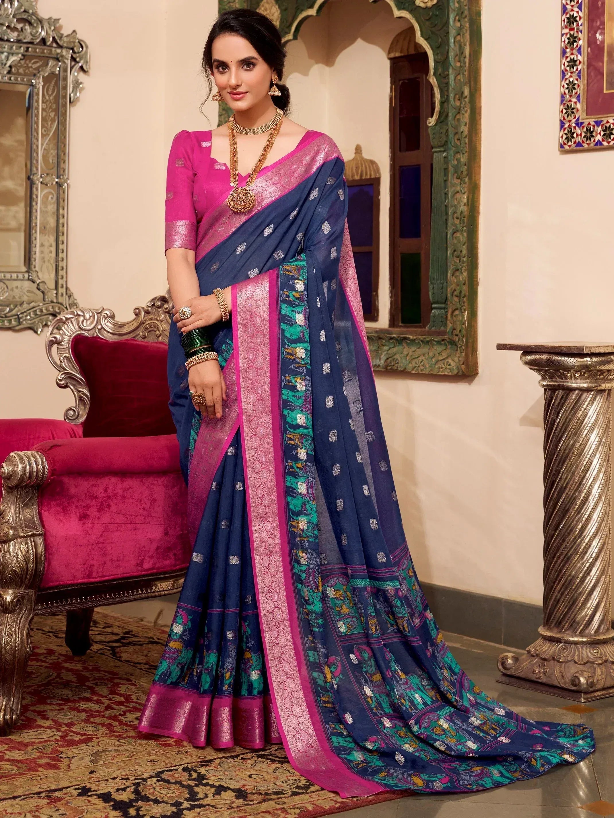Woman in navy blue and pink printed saree with elephant motifs, traditional Indian ethnic wear