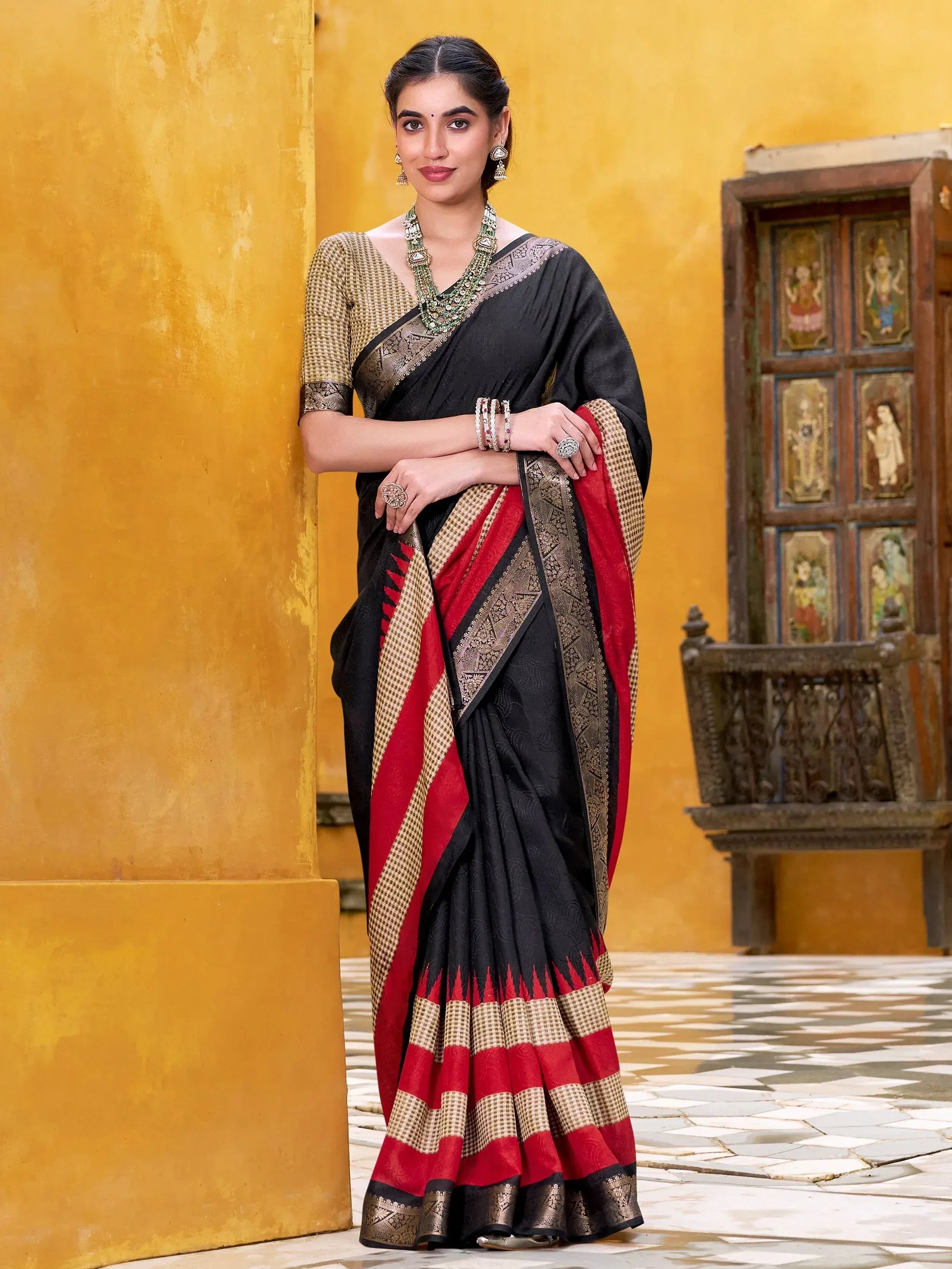Black and red ethnic saree with gold border, perfect for Indian occasions and festivals.