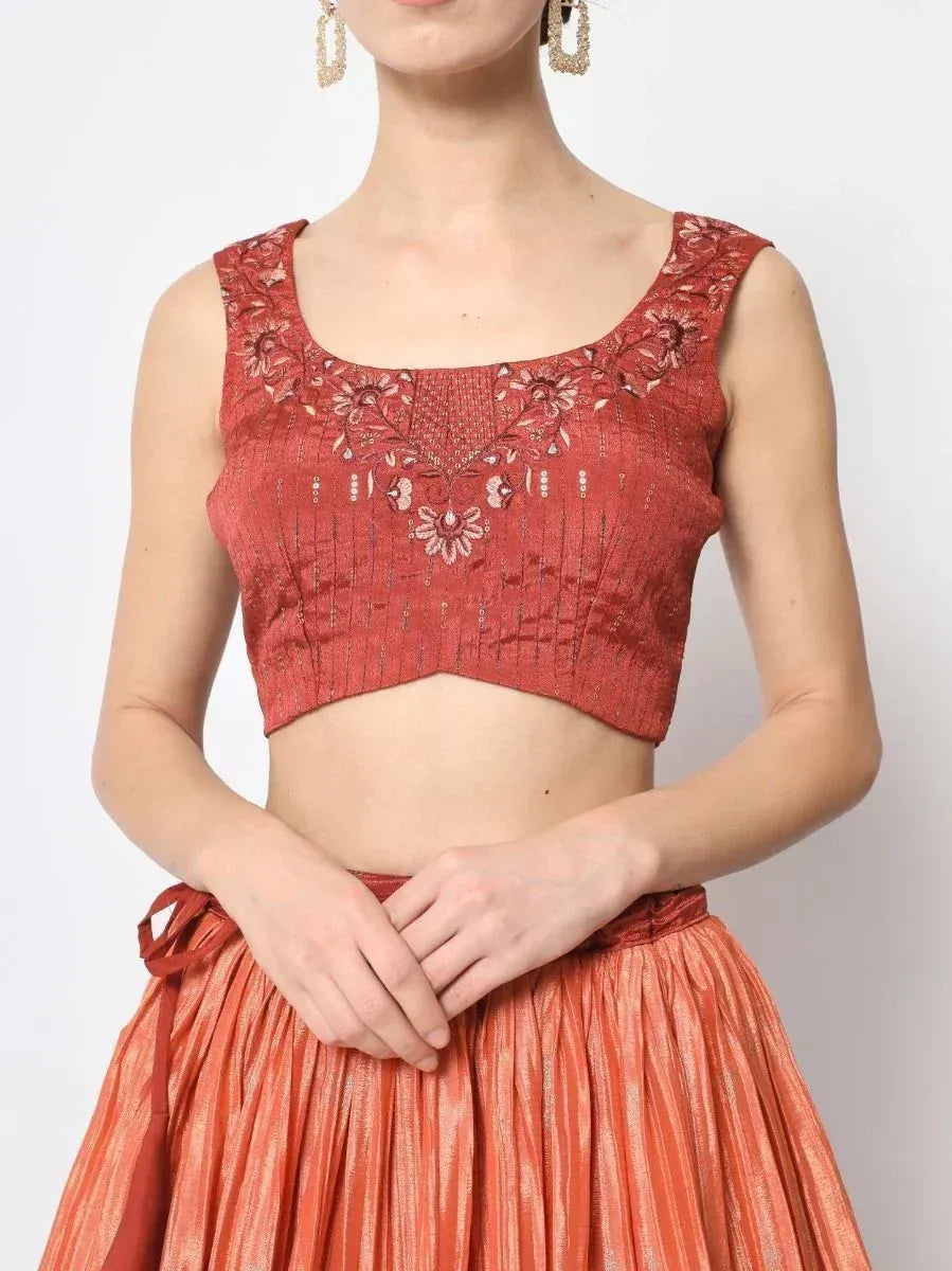 Red embroidered crop top with floral detailing, paired with pleated skirt for Indian ethnic wear