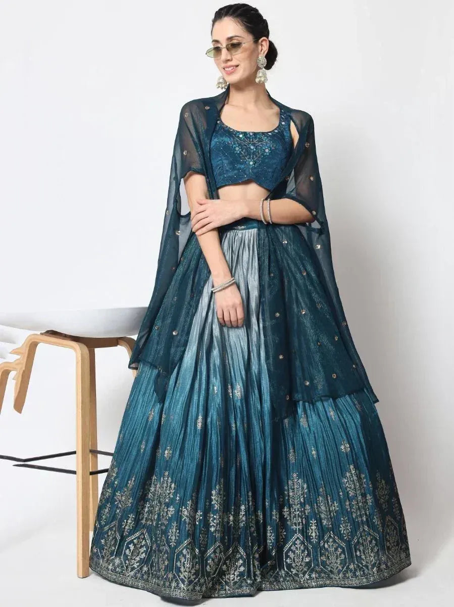 Teal designer lehenga choli with embroidered skirt and sheer dupatta, perfect for Indian ethnic wear events