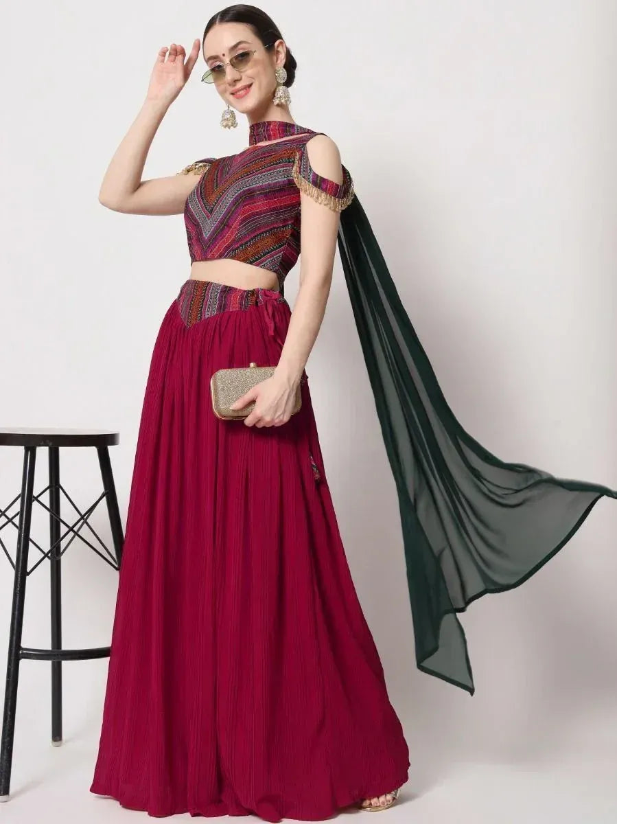 Maroon ethnic lehenga choli with printed crop top, sheer dupatta, and gold clutch for festive occasions