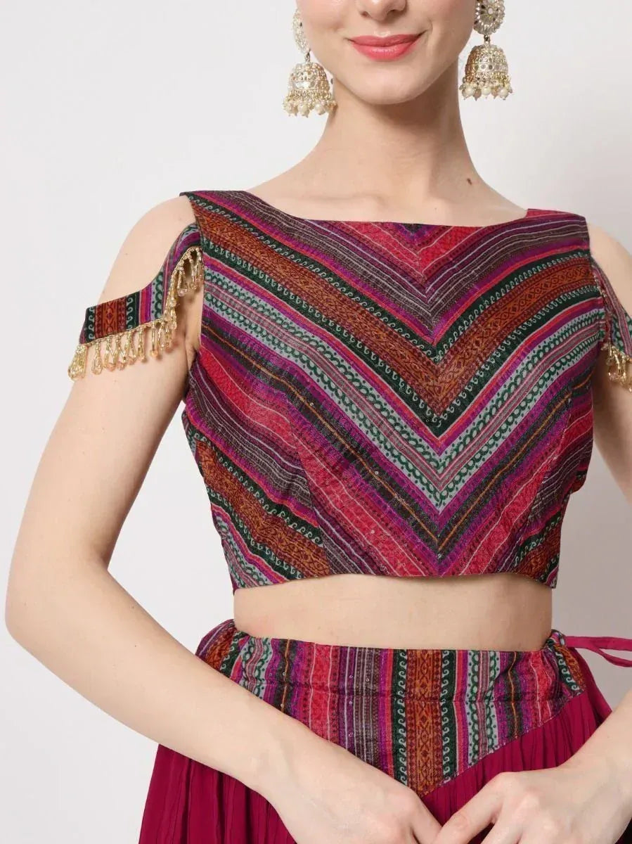 Ethnic crop top with chevron print & gold tassels, paired with matching skirt, ideal for Indian festive wear