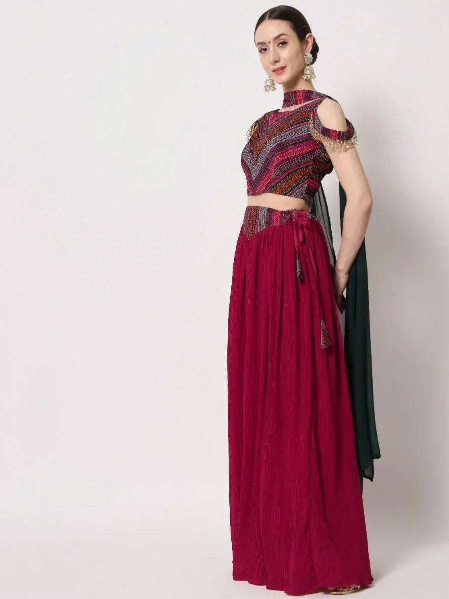 Woman in maroon ethnic lehenga choli with patterned crop top and green dupatta, perfect for Indian occasions