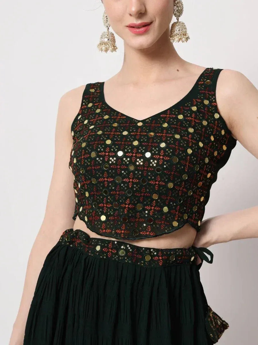 Black ethnic crop top with mirror and red embroidery, paired with matching skirt for Indian wear