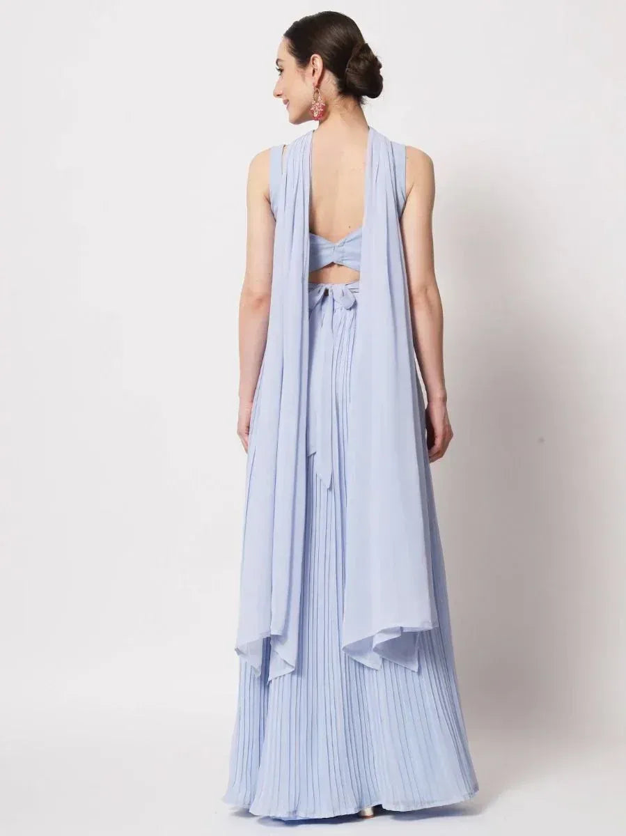 Light blue pleated ethnic gown with open back and draped dupatta, perfect for Indian occasions