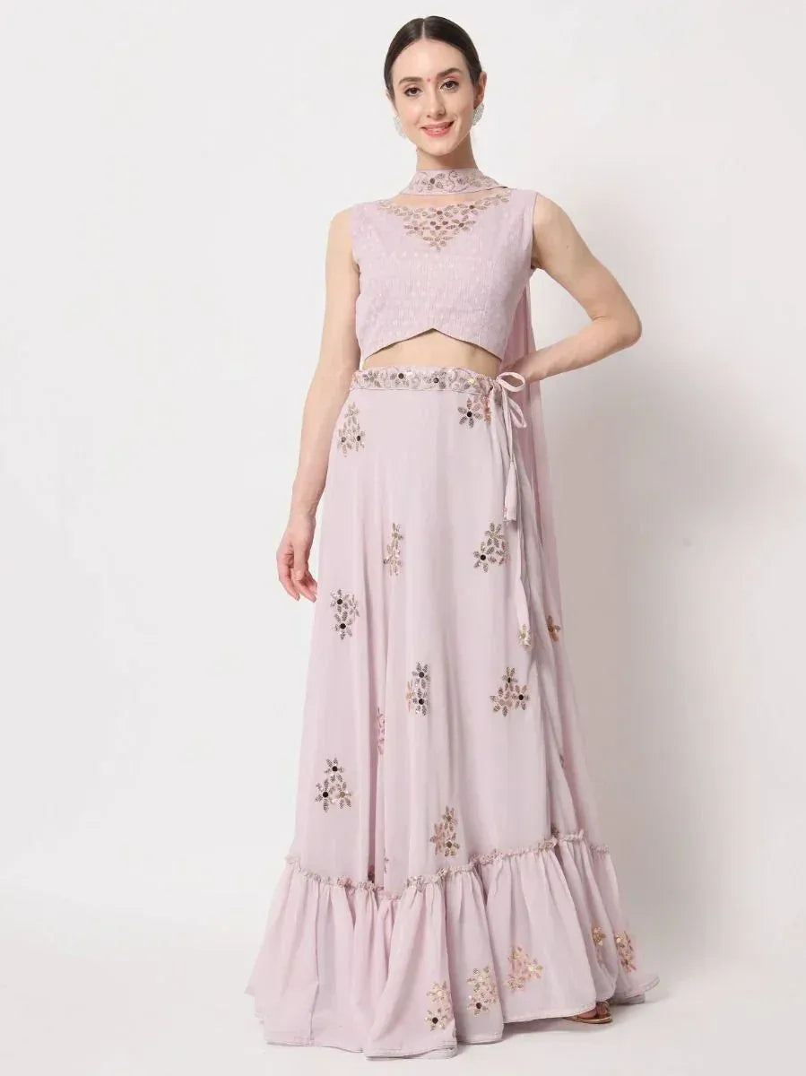 Light pink embroidered lehenga choli with floral motifs and ruffled hem, perfect for ethnic occasions