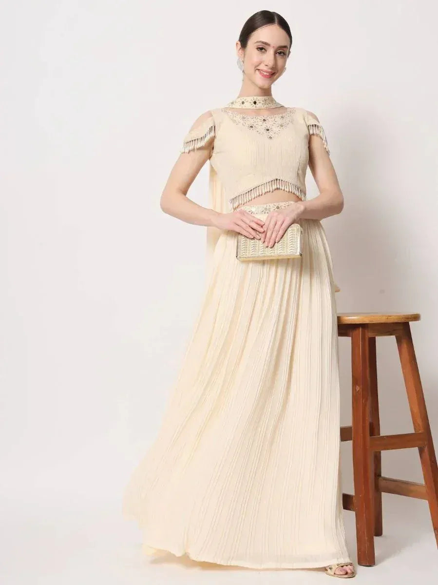 Cream embroidered lehenga choli with fringe detailing, perfect for Indian ethnic occasions