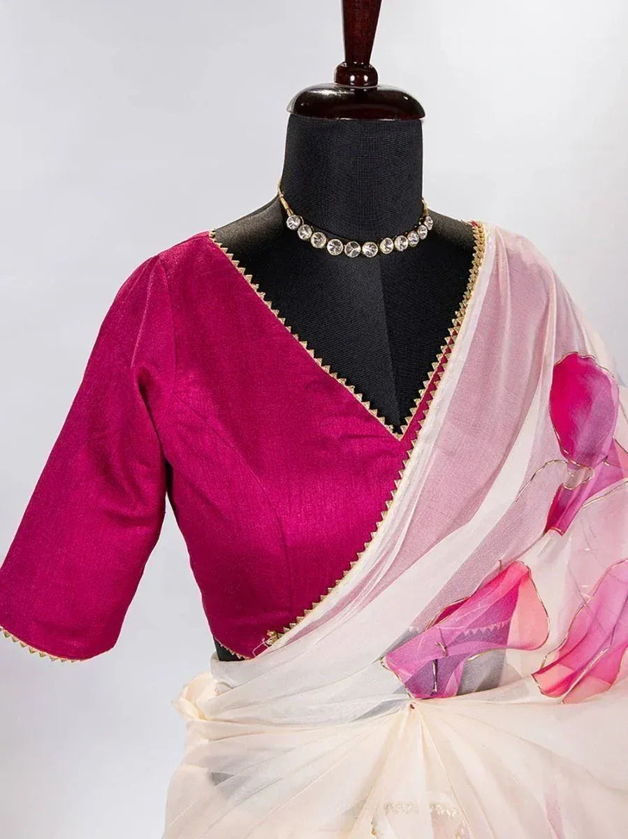Pink and white floral saree with magenta blouse, gold trim, displayed on mannequin