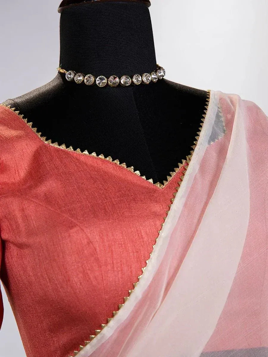 Pink saree with gold trim and crystal choker necklace, elegant Indian ethnic wear