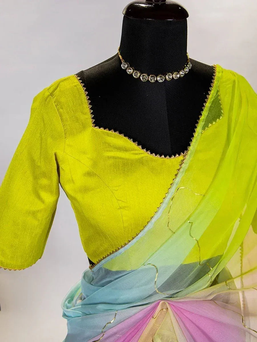 Vibrant lime green saree with ombre pastel pallu, gold trim, and matching blouse, styled on mannequin