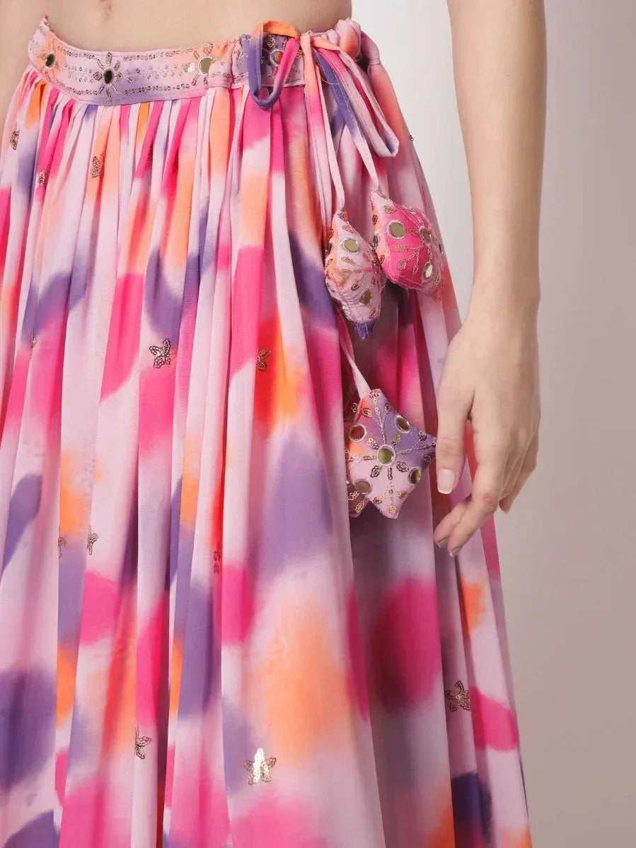 Colorful tie-dye ethnic skirt with embroidered butterflies and decorative tassels, perfect for festive occasions.